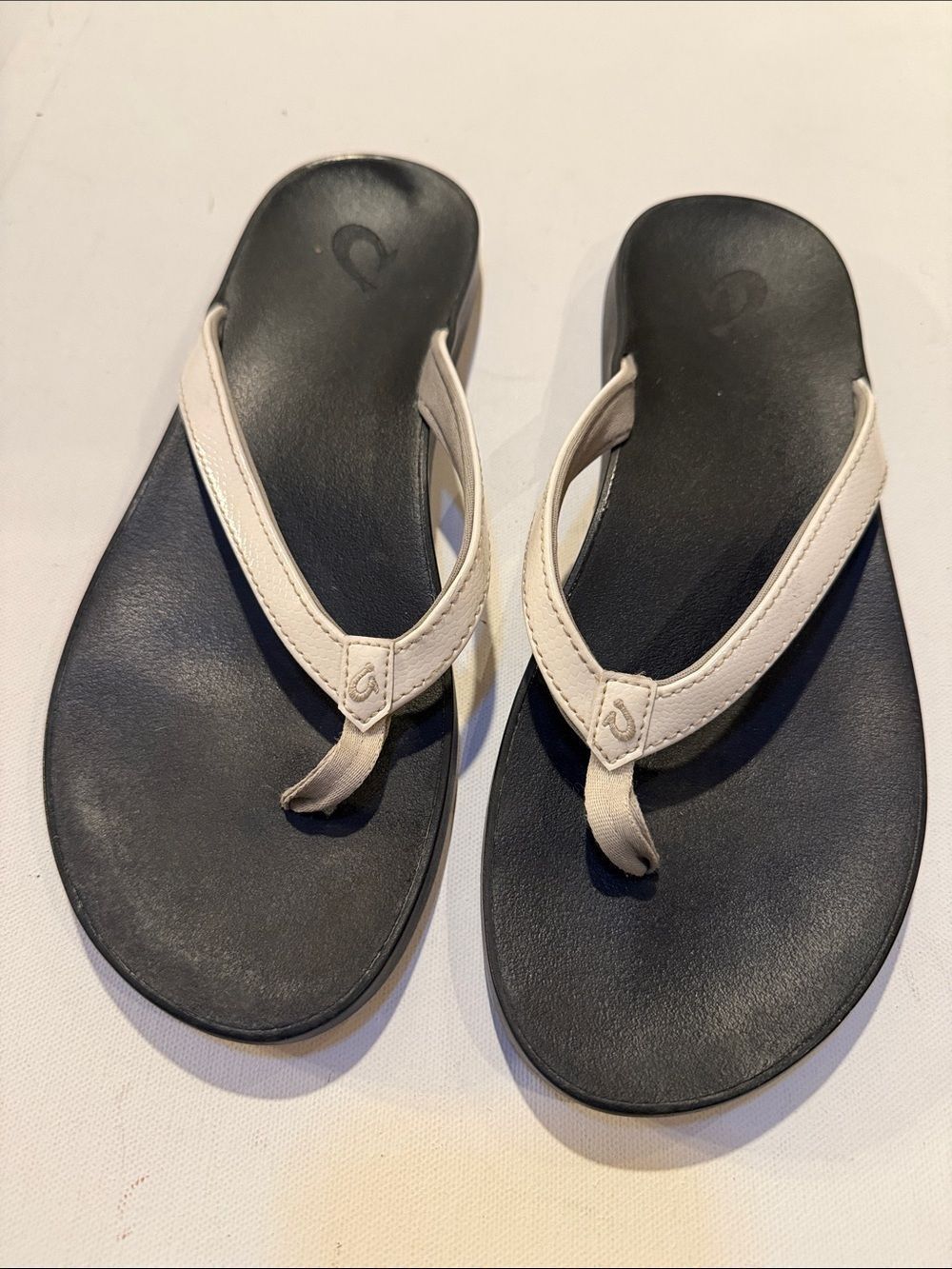 OluKai Black Footbed Sandals with Cream Straps